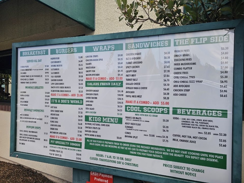 Menu board featuring breakfast, burgers, and wraps.
